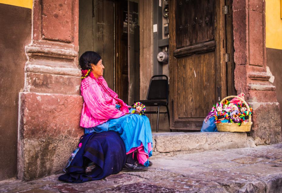 Indigenous mexican woman selling dolls