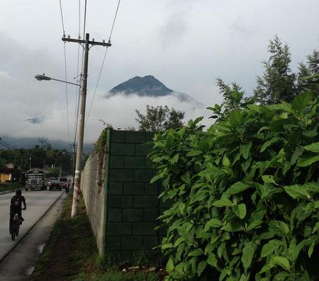 Photo: Volcán de Agua [Water Volcano] appears in the background of an avenue in the city of Antigua, Guatemala. Credit: Astrid Puentes.