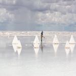 Worker performing harvesting salt on the salt lake Salar de Uyuni, Bolivia