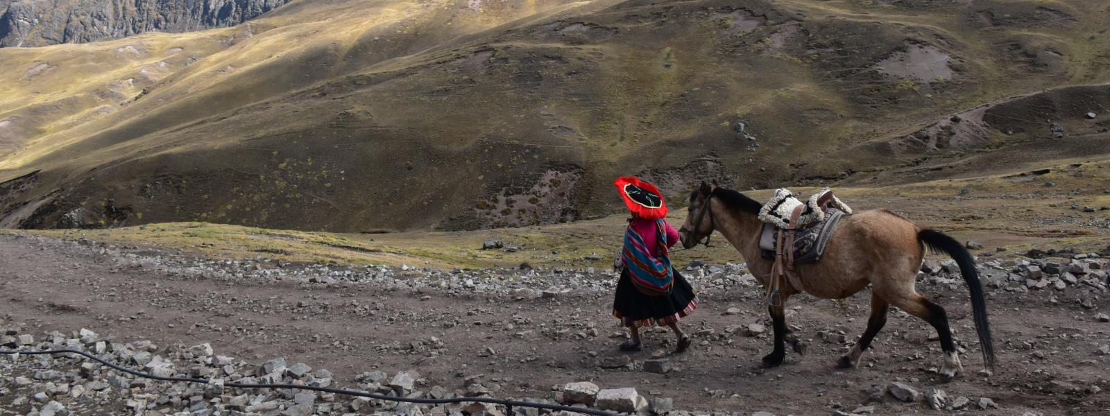 Woman and horse in the mountains of Peru