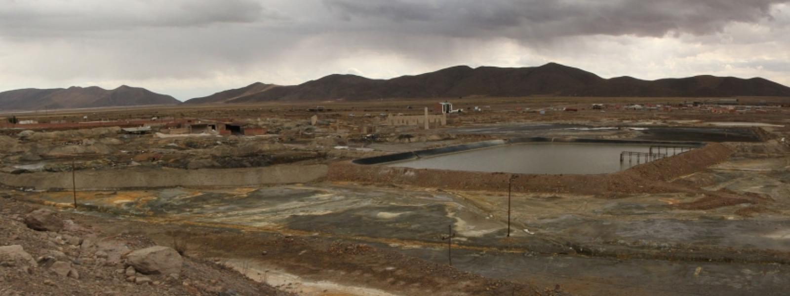 At the entrance to Poopó, the landscape includes pools of mining waste and damaged soil.