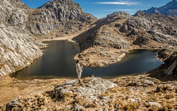 Indigenous man overlooking Laguna Katchiminka, Sierra Nevada de Santa Marta, Colombia
