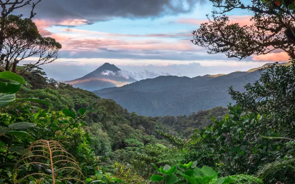 tropical mountainside with volcano in distance